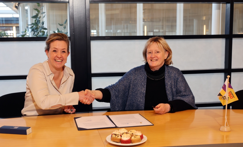 Bente Simons (links) en Antoinette Laan (rechts) tekenen de samenwerkingsovereenkomst